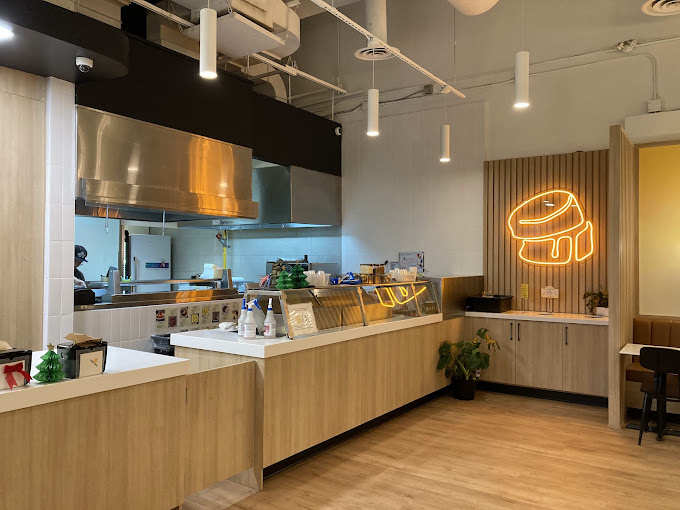 Fuwa Fuwa service counter with display cases and neon sign