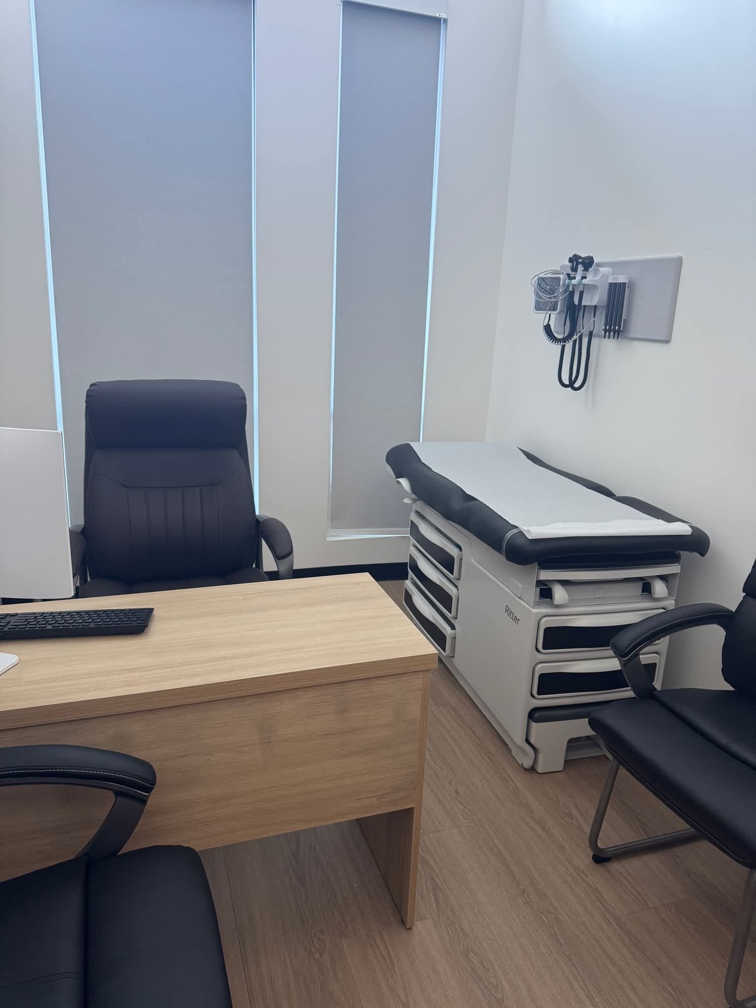 Grace Medical Clinic reception and waiting area with backlit logo wall and pharmacy shelving
