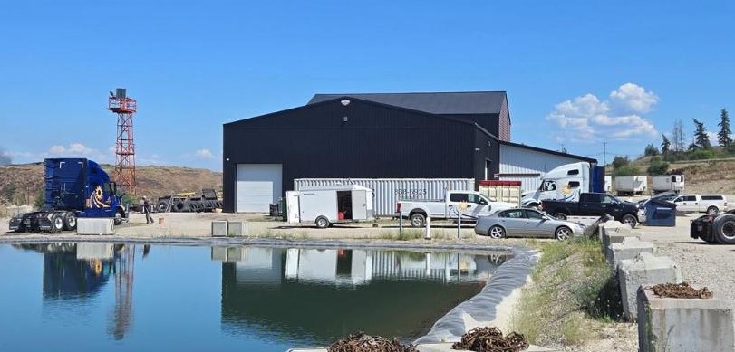 Integrity Buildings exterior with retention pond and equipment yard