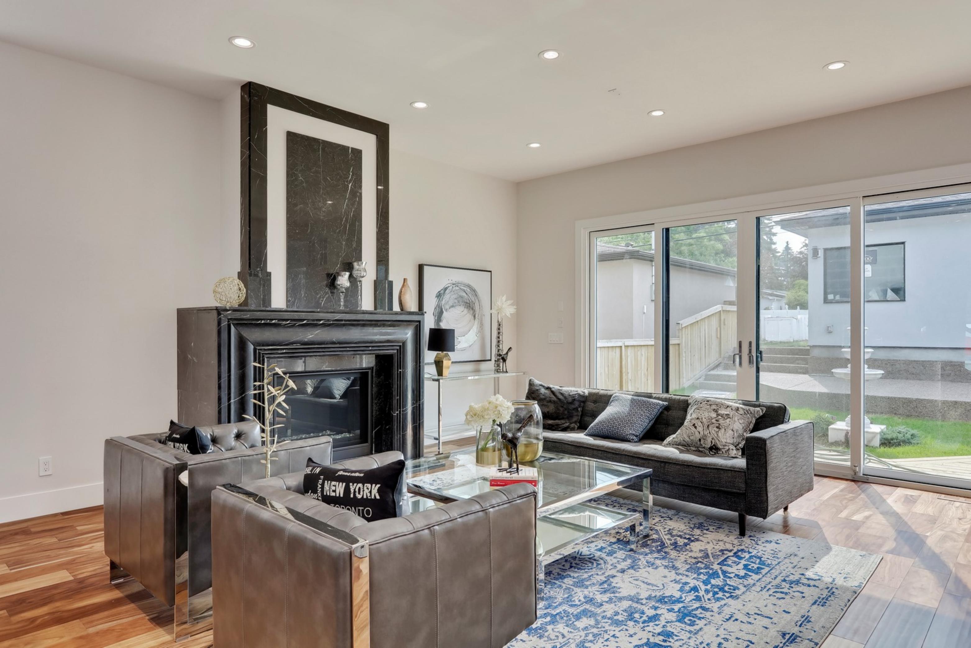 Killarney Custom Residence living room with black marble fireplace and leather seating