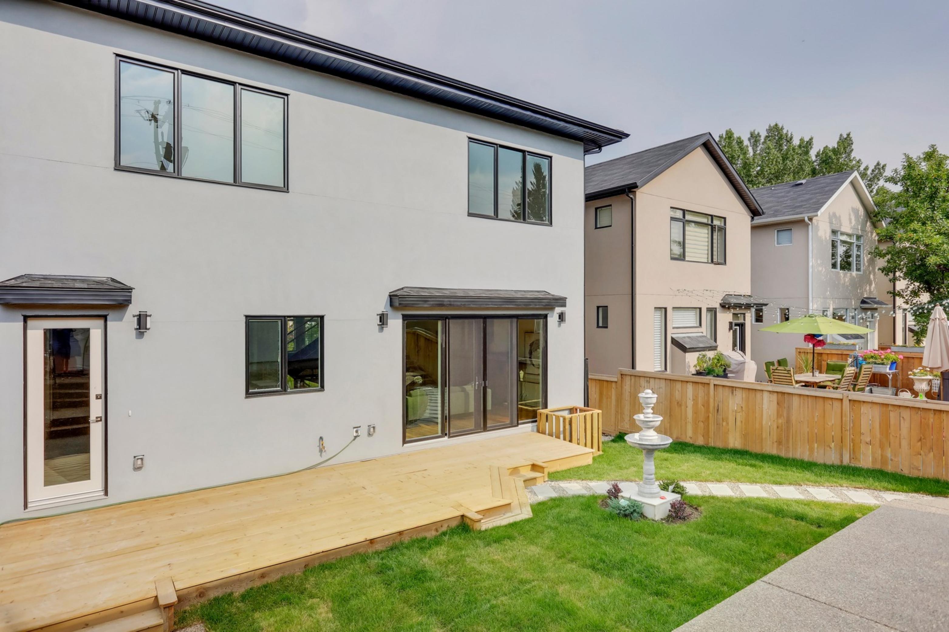 Killarney Custom Residence rear exterior with deck and sliding glass doors