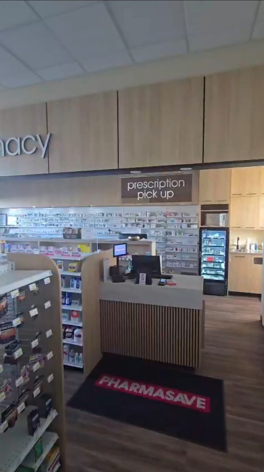 Pharmasave Sage Hill prescription pickup counter with shelving