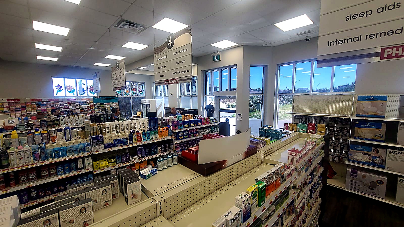 Pharmasave Sylvan Lake retail aisle with category signage